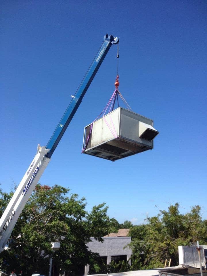 Crane removes aging rooftop unit